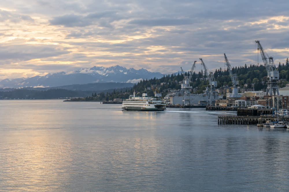 Shipyard cranes and a car ferry on the water at Bremerton