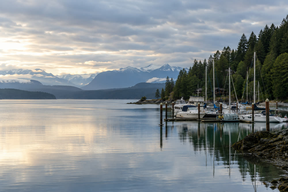 A calm bay at Silverdale with a small marina and the Olympic Mountains